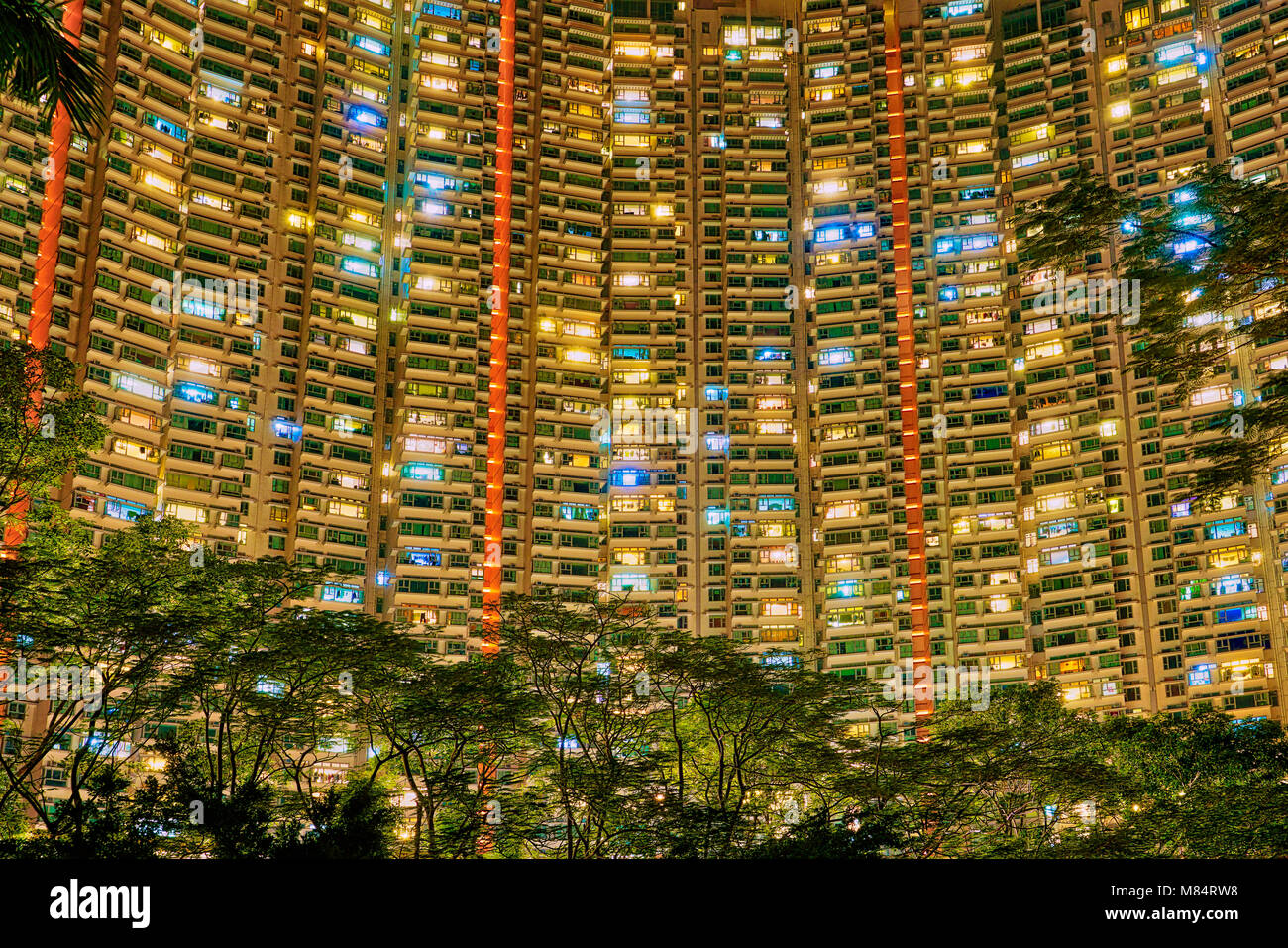 Hochhäuser in Hongkong nach Sonnenuntergang w Leuchten in den Appartments Stockfoto