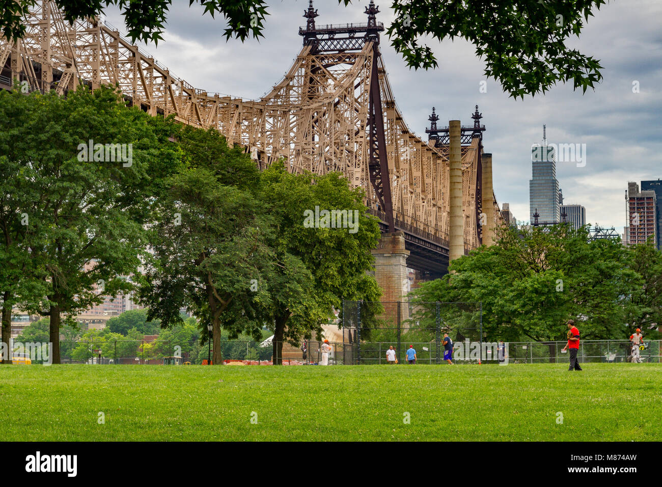 Sonntag morgen Baseball in einer Stadt Park unterhalb der 59th St Queensboro Bridge, Long Island City, Queens, New York, NY, USA gespielt Stockfoto