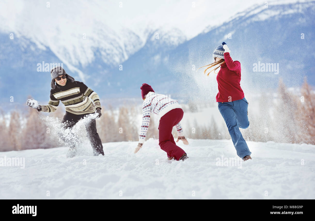 Gruppe von drei glückliche Freunde Spaß spielen Schneebällen. Winterurlaub Konzept Stockfoto