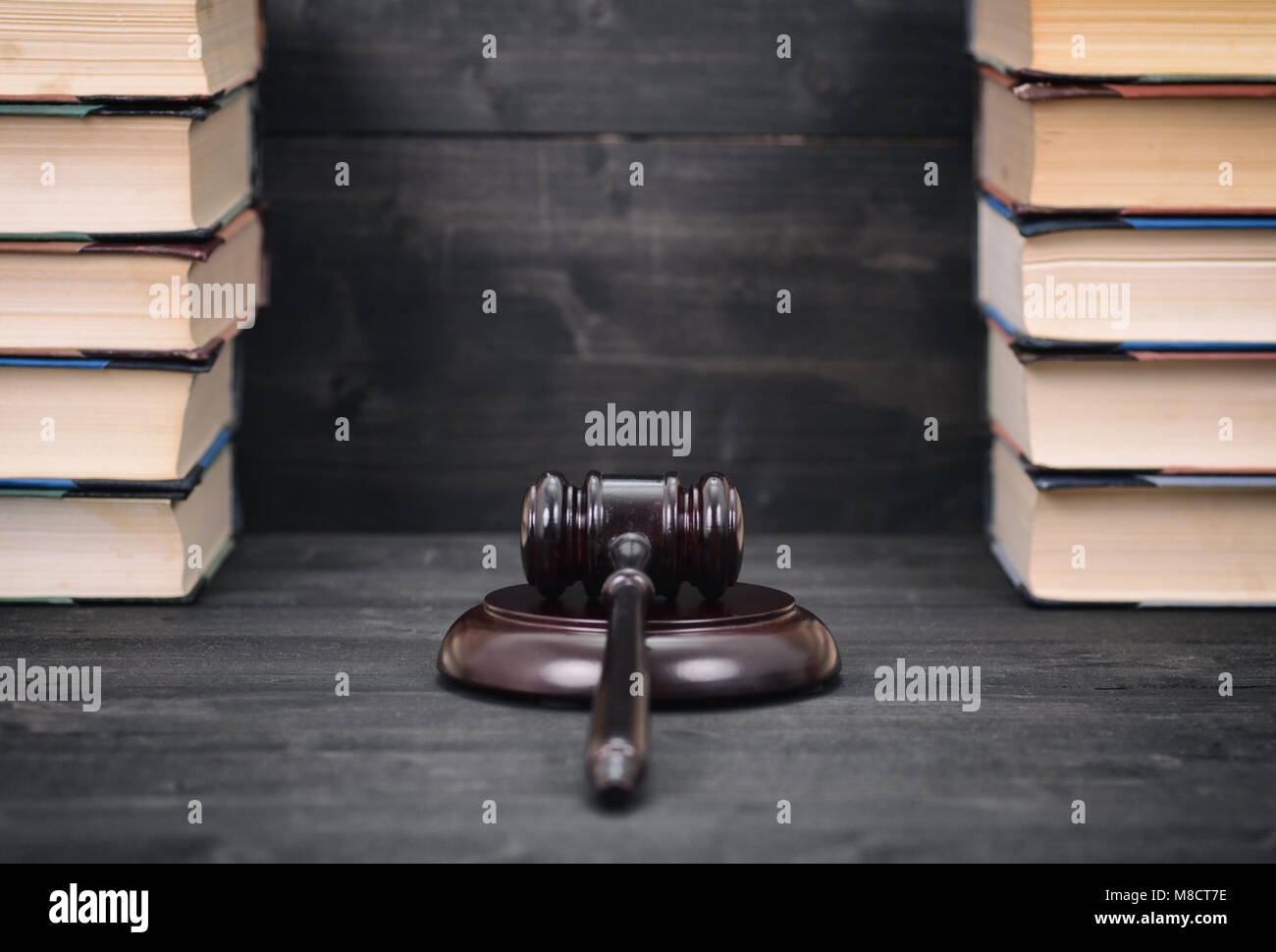 Recht und Gerechtigkeit, Rechtmäßigkeit Konzept, Richter Hammer und recht Bücher auf einem schwarzen Holz- Hintergrund, juristische Bibliothek Konzept. Stockfoto