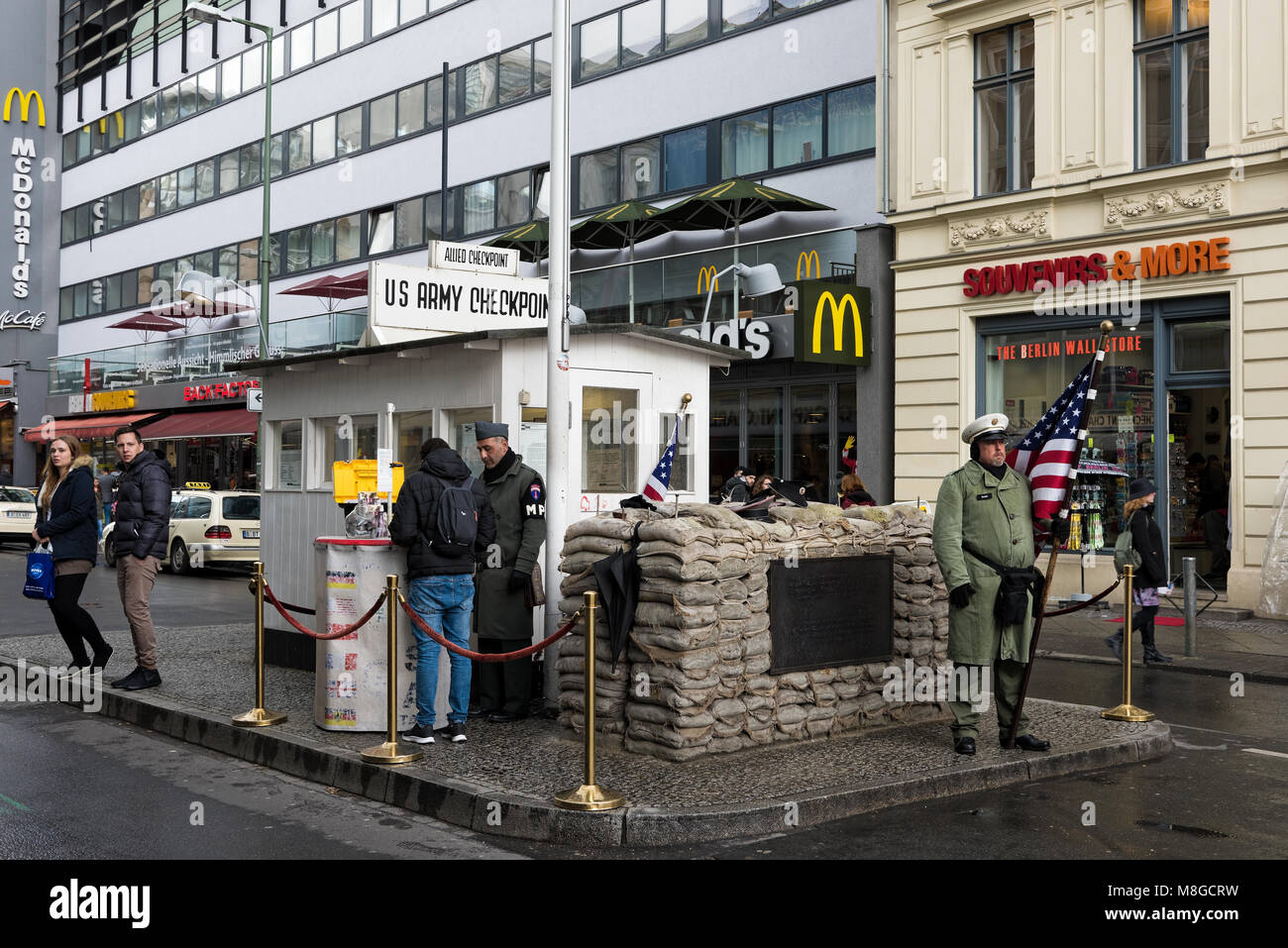 Männer tragen amerikanische militärische Uniformen stehen am berühmten Checkpoint Charlie am 19. April 2017 in Berlin, Deutschland. Stockfoto