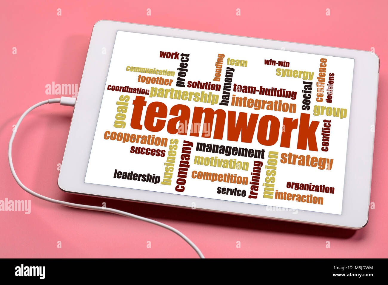Teamwork Wort Wolke auf einer digitalen Tablette gegen rosa Hintergrund Stockfoto