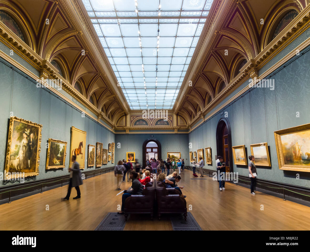 London, Großbritannien - 1 May 2017: Besucher des Londoner National Gallery beobachten den berühmten Gemälden von britischen Künstlern im Museum Sackler Zimmer. Stockfoto