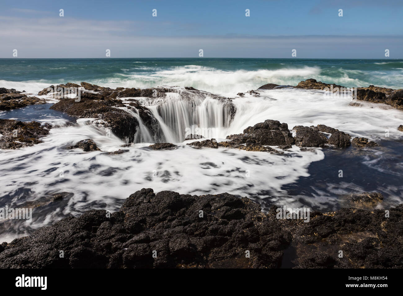 Thor ist gut am Cape Perpetua auf der Oregon Küste südlich von Florenz, Oregon ist eine natürliche Felsformation, die Abflüsse der Absturz der Brandung, wie es ist, die ein Ablassen. Stockfoto