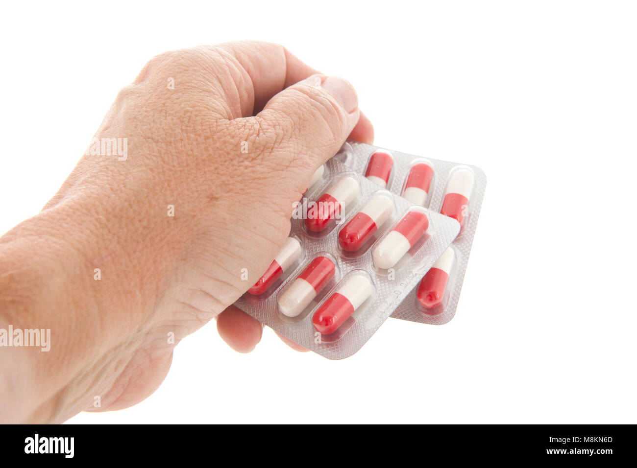 Die Verpackung der Tabletten. Kapseln in Rot und Weiß in der Alten Hand  Stockfotografie - Alamy