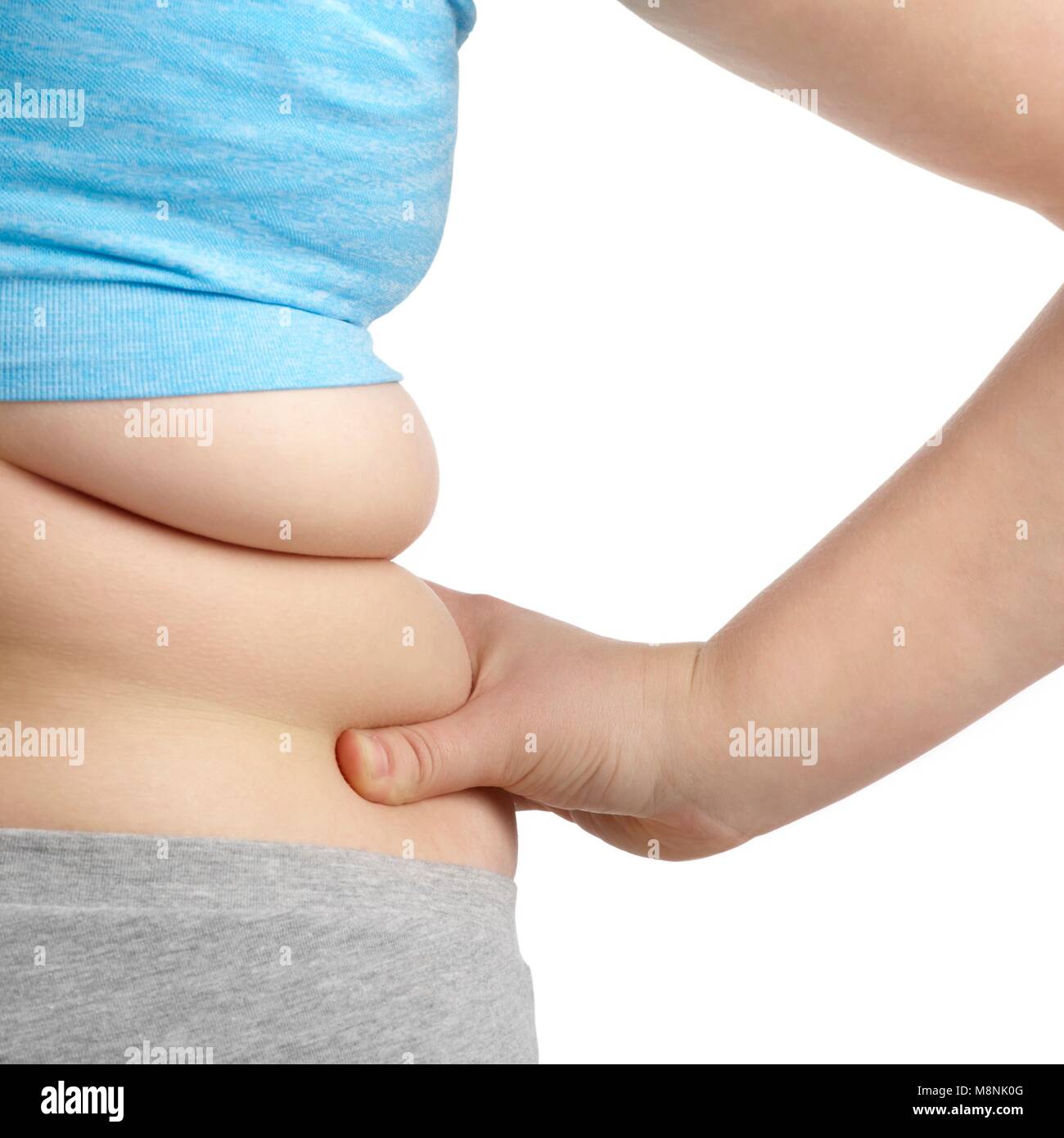 Übergewichtige Frau mit der Hand auf der Hüfte. Stockfoto