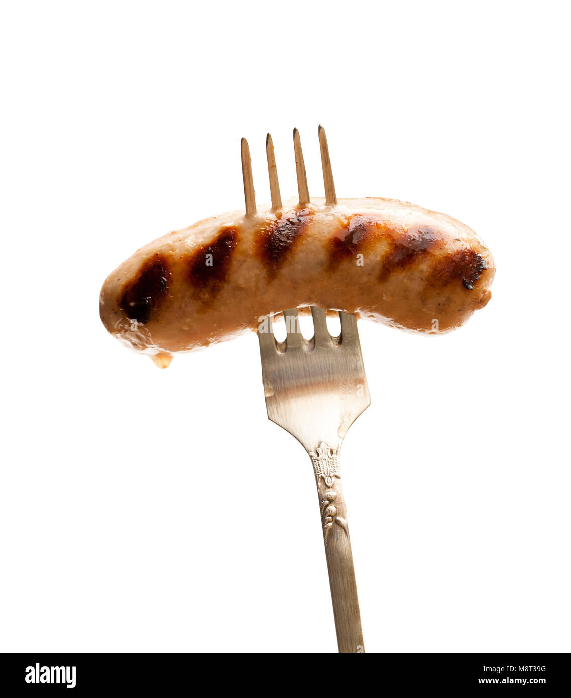 Gegrillte Würstchen auf vintage Gabel isoliert auf weißem Stockfoto