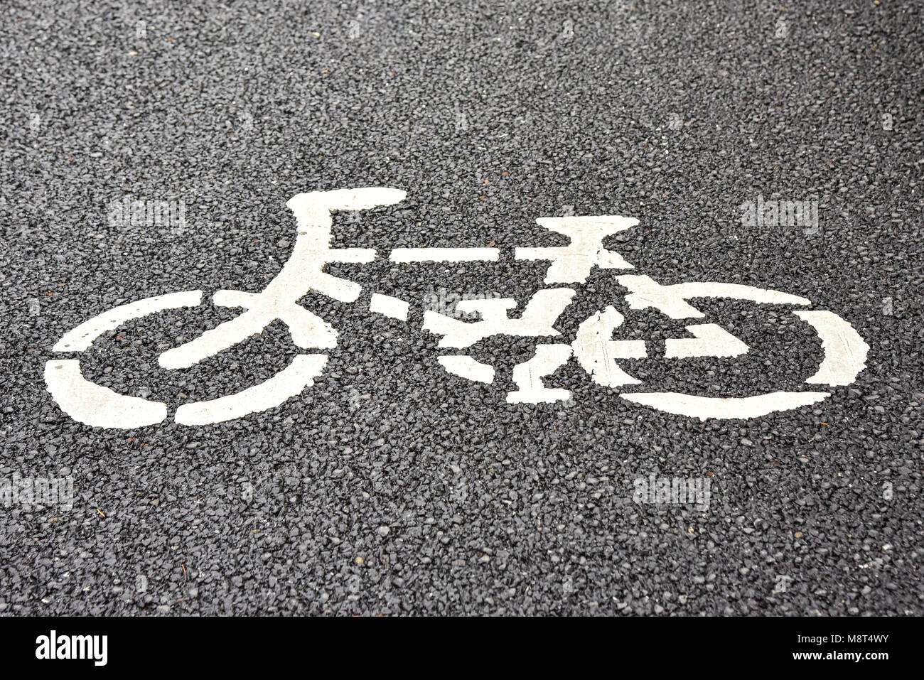 Weiß Fahrradsymbol auf Asphalt für einen Radweg gemalt. Stockfoto