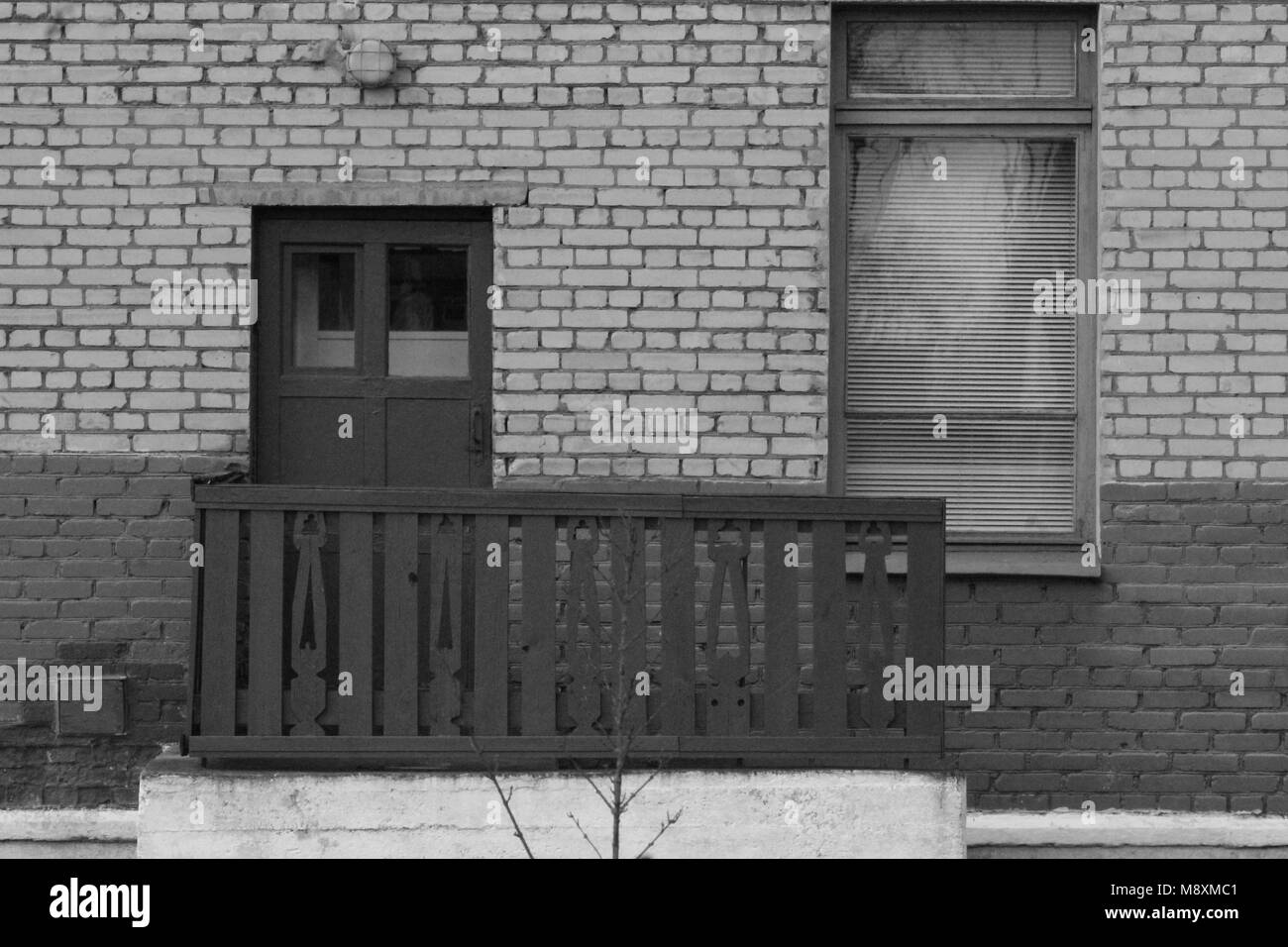 Zwei Teile Holztür mit Balkon und schmalen Fenster in der Wand Dekor in der Architektur Stockfoto