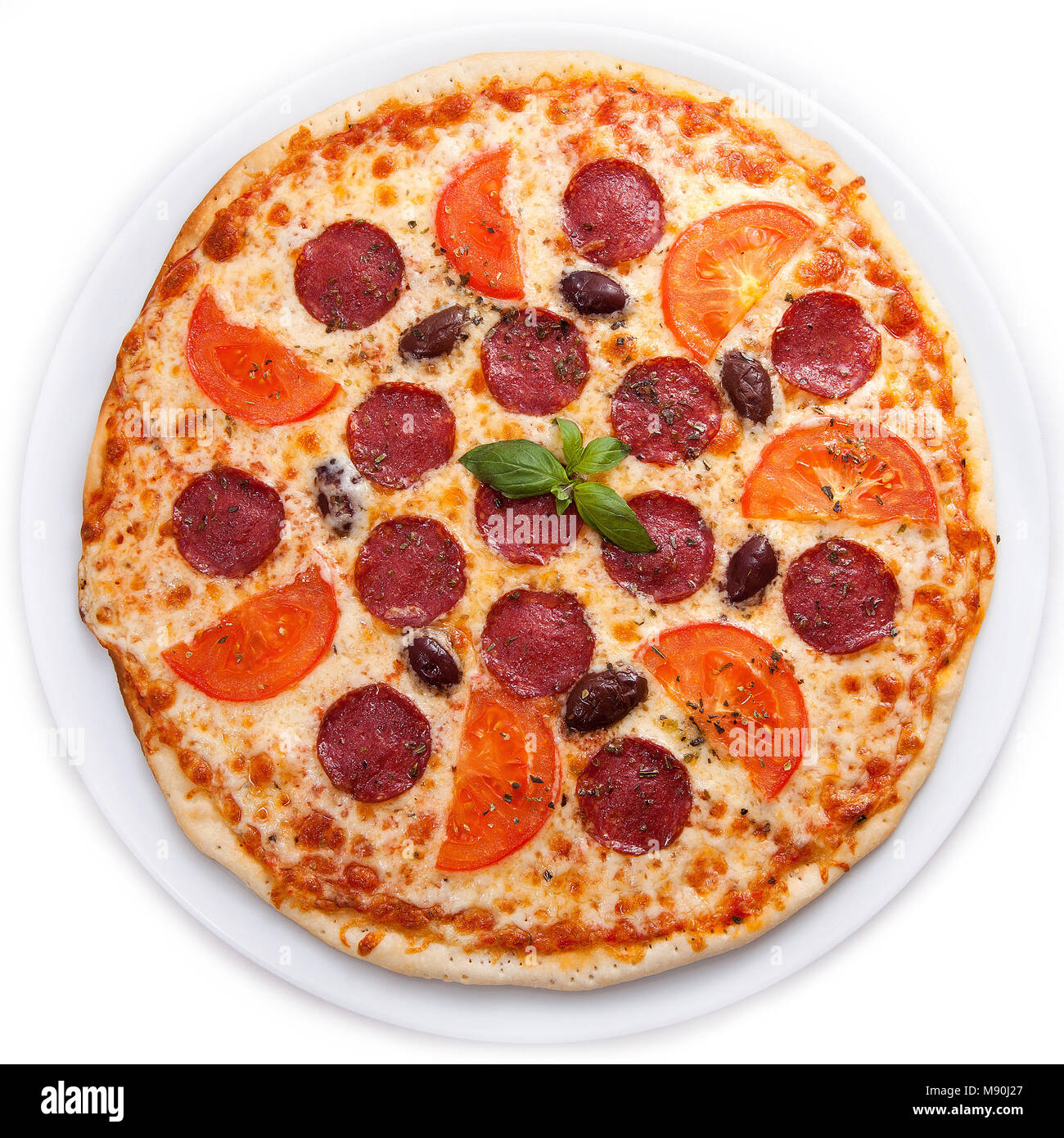 Pizza mit Salami und Tomaten/Paradeiser Stockfoto