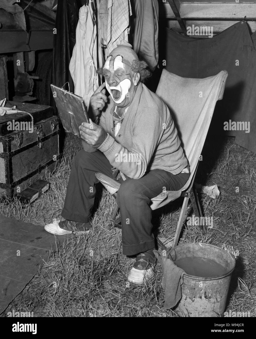 Ein Clown gilt Fett Farbe vor einer Show, Ca. 1953. Stockfoto