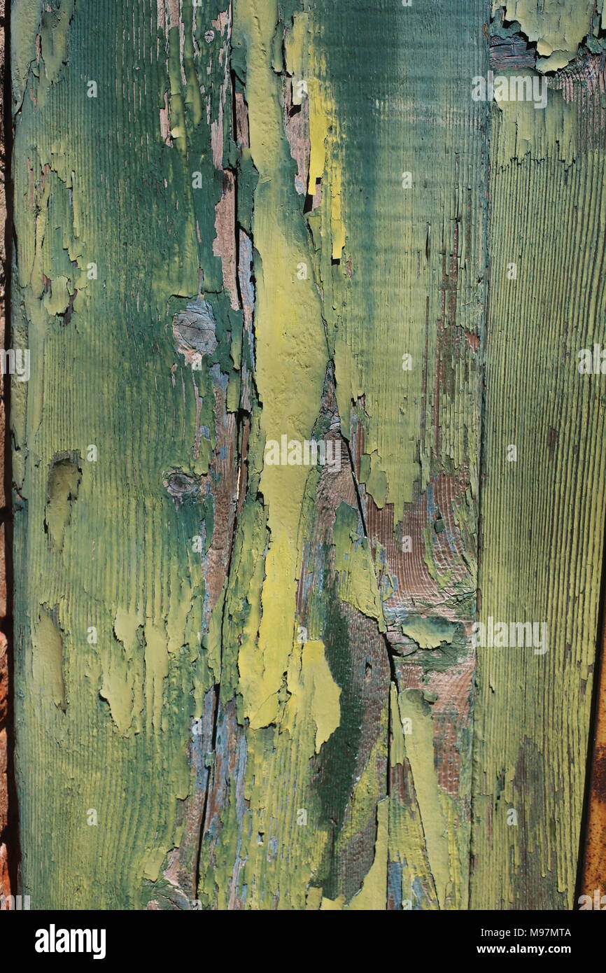 Ein in der Nähe eines alten, verrottenden Holztür mit vielfarbigen Schichten abblätternder Farbe Stockfoto
