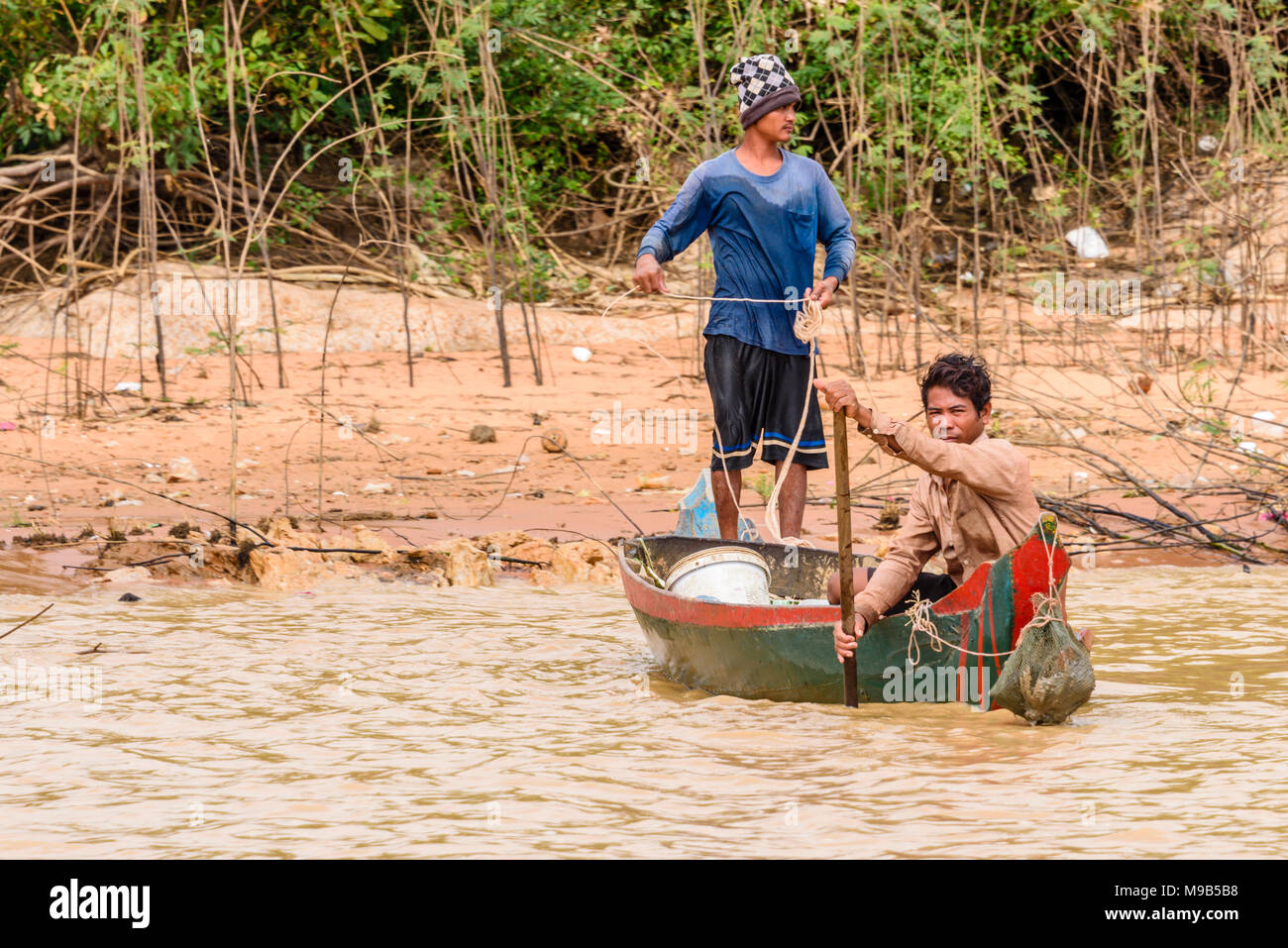 Zwei Fischer auf einem Boot auf dem Fluss Siem Reap Angeln für Muscheln. Siem Reap, Kambodscha. Stockfoto