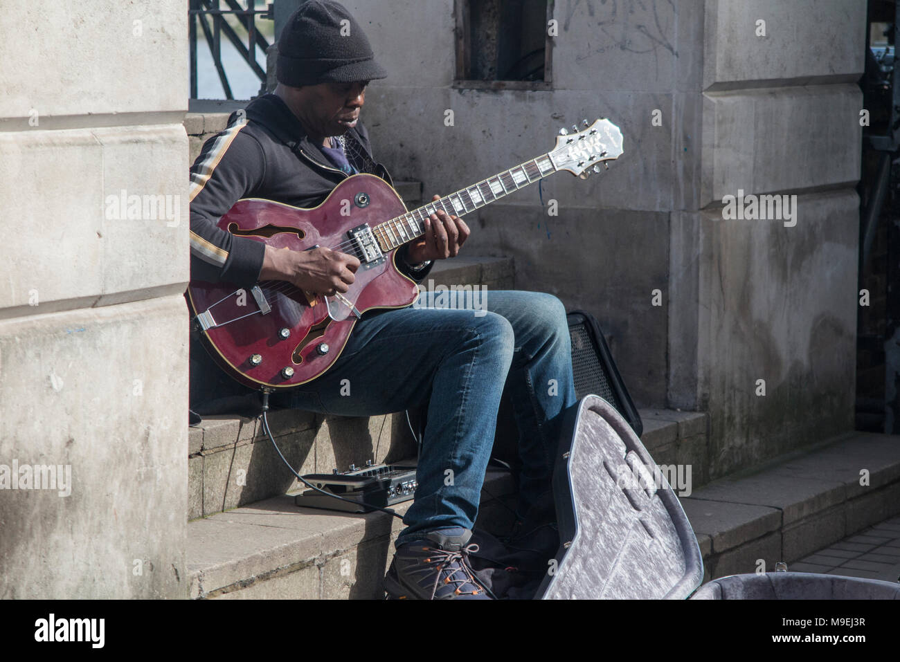 Ein strassenmusikant führt einige Jazz und Blues in der Sonne am Ufer der Themse Stockfoto