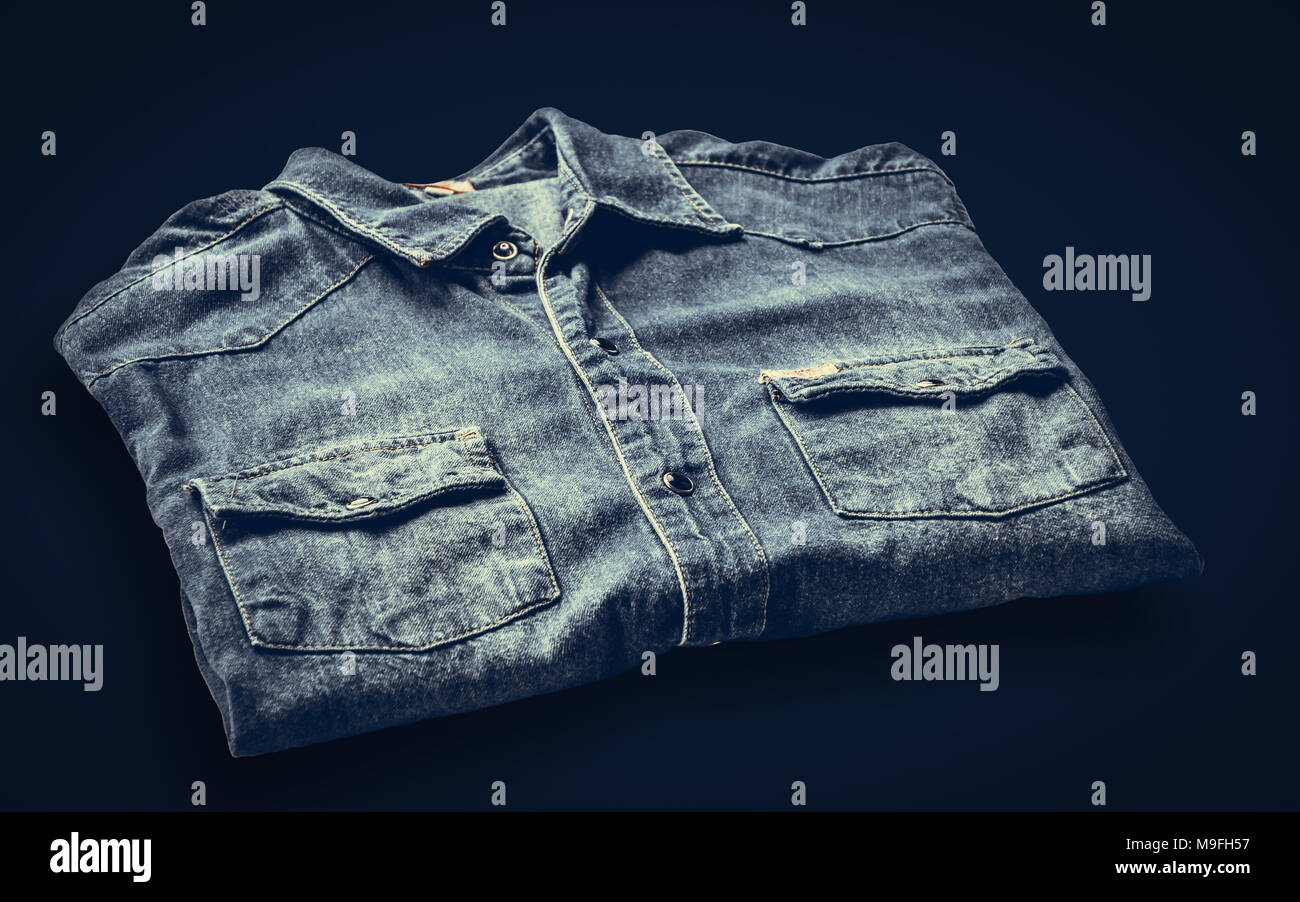 In der Nähe von blauen Shirts Jeans auf dunklem Hintergrund Stockfoto