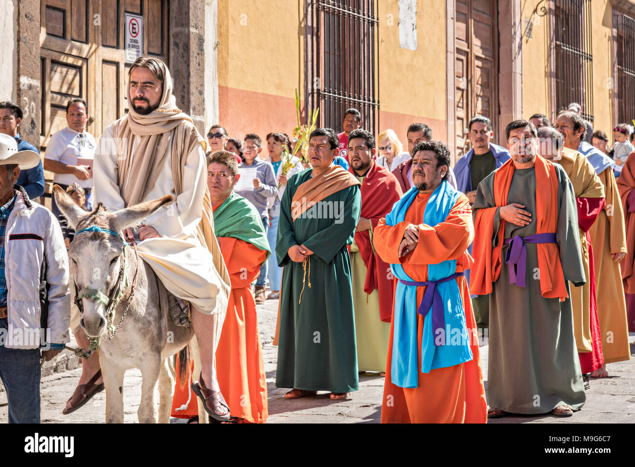 San Miguel de Allende, Mexiko. 25 Mär, 2018. Jesus reiten Burro führt seine Jünger in einem Palmsonntag Prozession durch die Straßen zu Beginn der Karwoche, 25. März 2018 in San Miguel de Allende, Mexiko. Die Christen, die Jesus in Jerusalem gedenken, wenn man glaubte, dass die Bürger die Palmzweige in den Weg gelegt. Credit: Planetpix/Alamy leben Nachrichten Stockfoto
