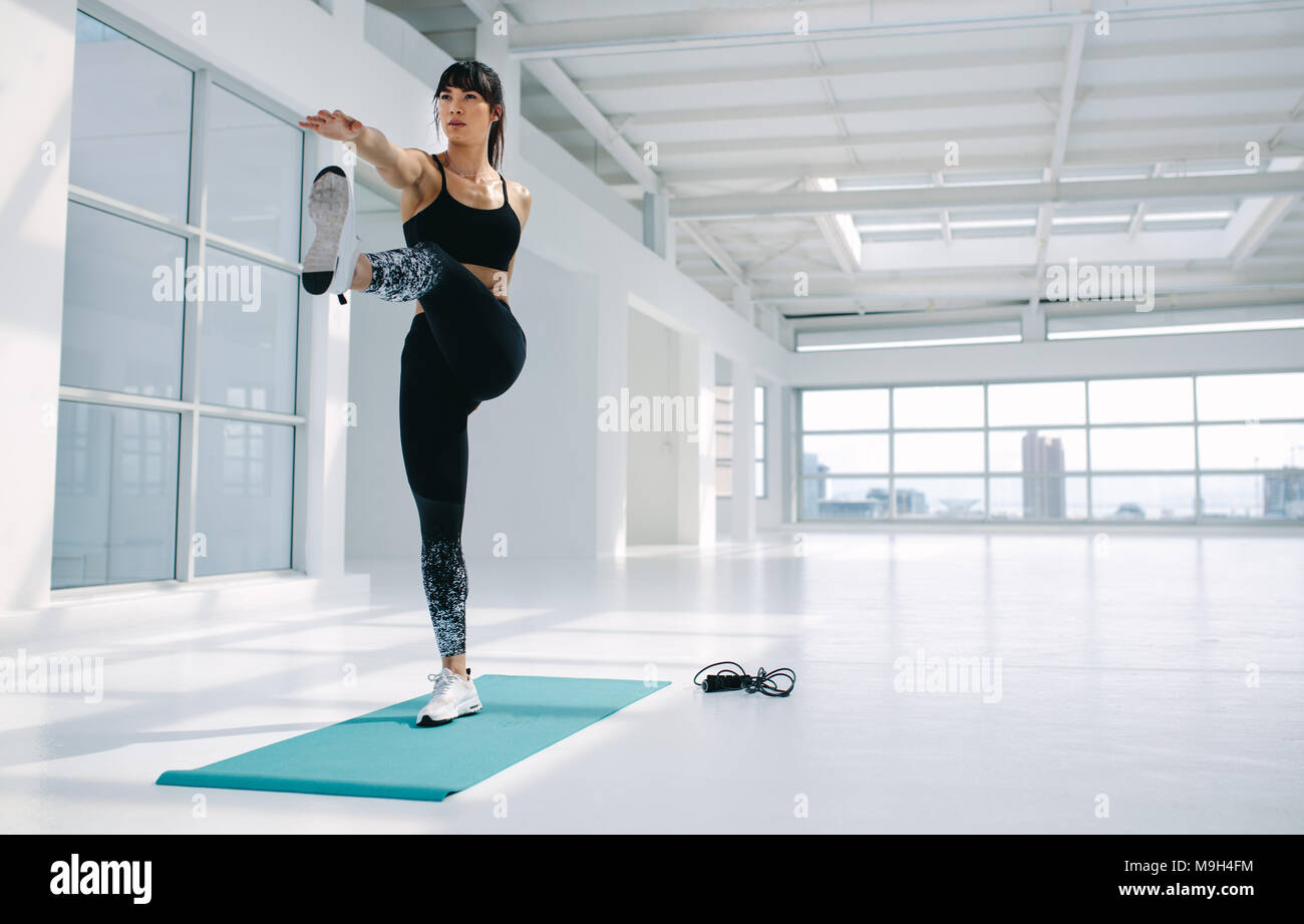 Kaukasische Frau in ständigen Big Toe hold Pose im Fitnessstudio. Weibliche Yoga Asana im Fitness Studio. Stockfoto