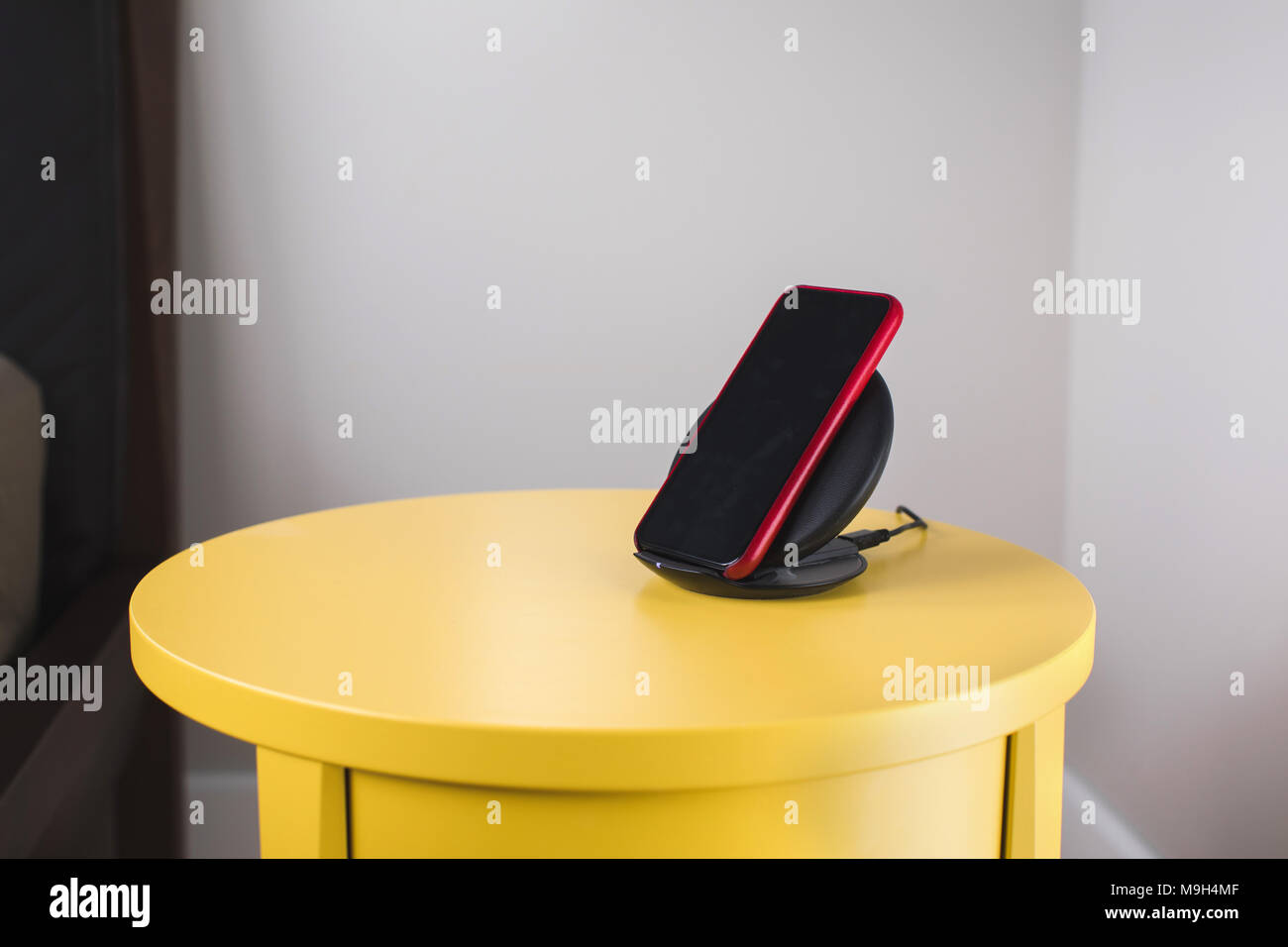 Smartphone mit einem drahtlosen schnellen Ladestation Stockfoto