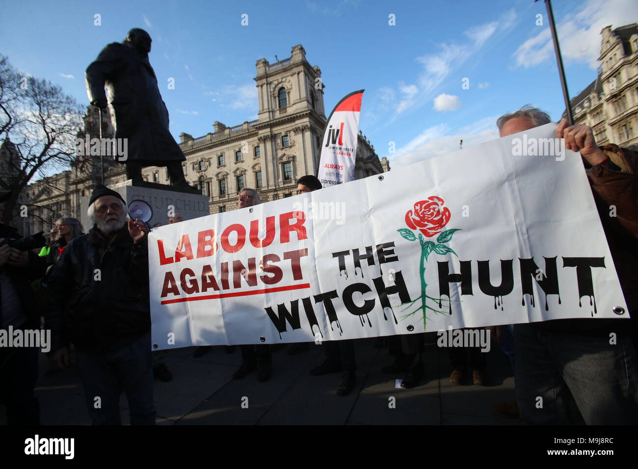 Anhänger der Labour-Partei halten ein Banner, während Menschen in der Labour-Partei auf dem Parliament Square in London gegen den Antisemitismus protestieren, während jüdische Gemeindeführer einen vernichtendem Angriff auf Jeremy Corbyn gestartet haben, der behauptet, er habe sich „immer wieder“ auf die Seite der Antisemiten gestellt. Stockfoto