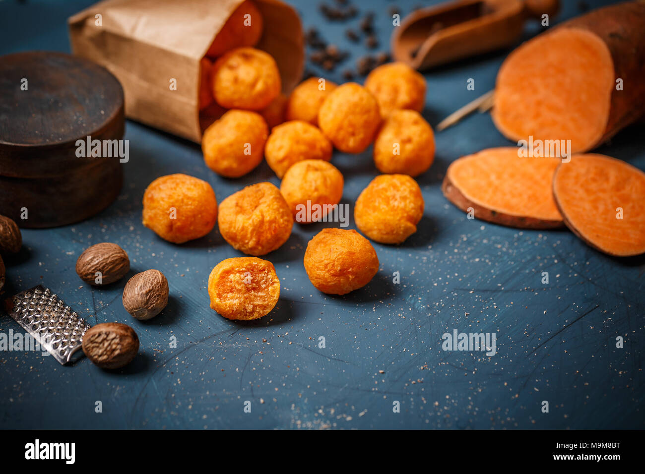 Pürierte Süßkartoffel Kugeln auf blauem Hintergrund Stockfoto