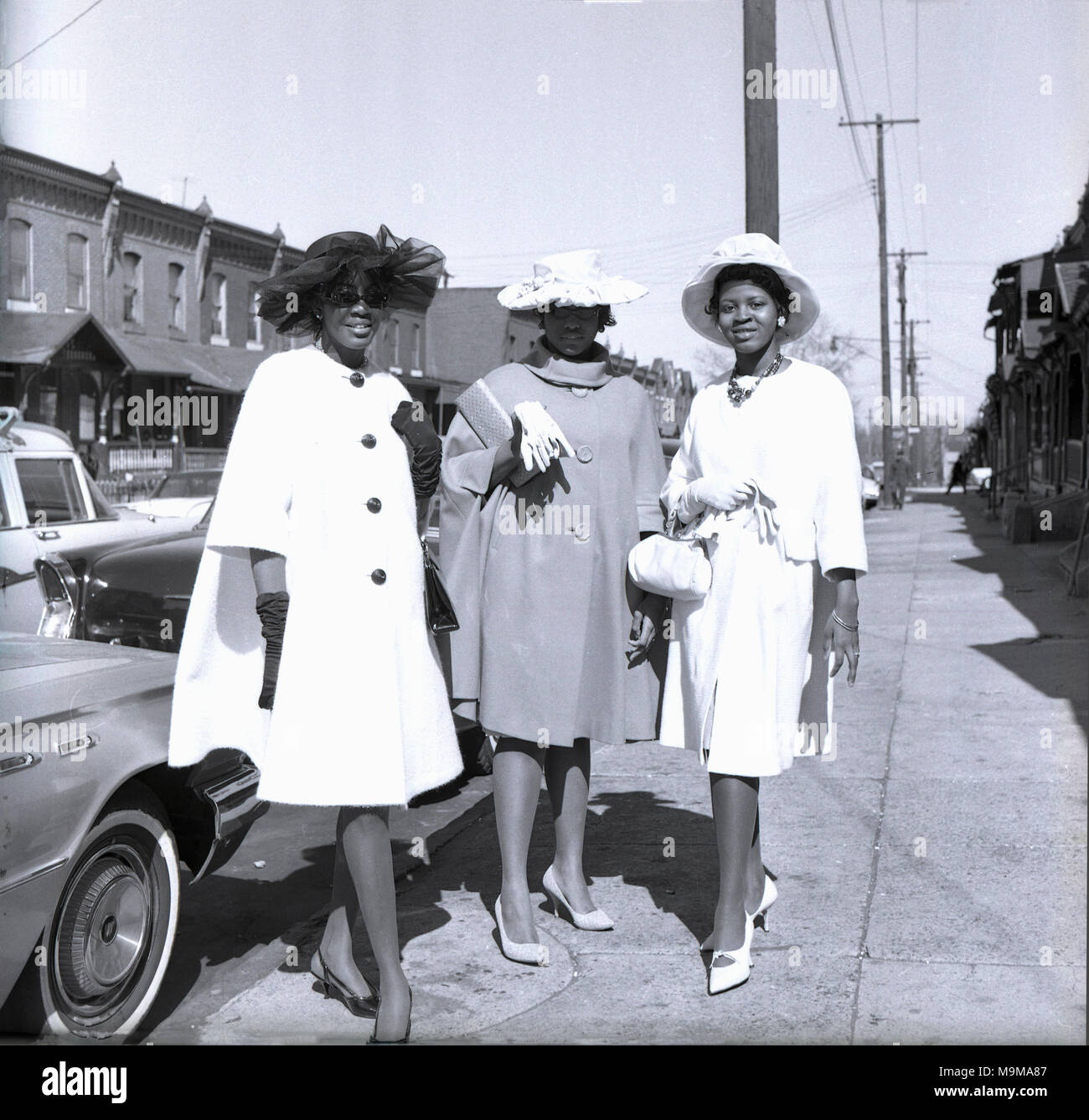 1960, Philadelphia, USA, drei attraktive, elegante und gut gekleidete Damen auf einem Tag stand auf dem Bürgersteig in der Stadt, tragen modische Schuhe, Mäntel und Hüte und eher schick. Stockfoto