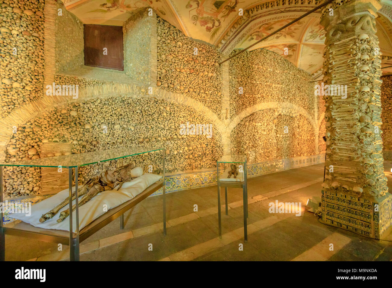Evora, Portugal - 18. August 2017: getrocknete Leichnam in der Kapelle der Knochen oder Capela dos Ossos, einer der am meisten besuchten Sehenswürdigkeiten von Evora. Wände und Säulen mit menschlichen Knochen und Schädeln geschmückt. Stockfoto