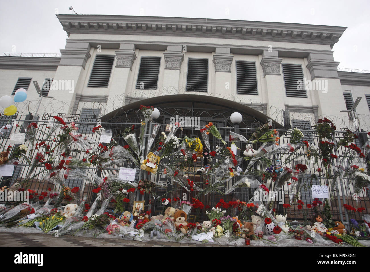 Kiew, Ukraine. 28. März, 2018. Blumen und Spielzeug im Gedenken für die Opfer des Feuers im Einkaufszentrum "Zimnyaya Vishnya" in der westsibirischen Stadt Kemerowo, sind vor der russischen Botschaft in Kiew, Ukraine, am 28. März 2018 gesehen. Berichten zufolge mindestens 64 Menschen, darunter 41 Kinder, in den tödlichen Vorfall am 25. März verstorben. Credit: Serg Glovny/ZUMA Draht/Alamy leben Nachrichten Stockfoto