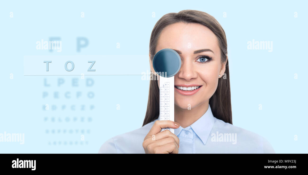 Frau Gesicht Überprüfung des Sehvermögens mit holographischen Auge Diagramm. Stockfoto