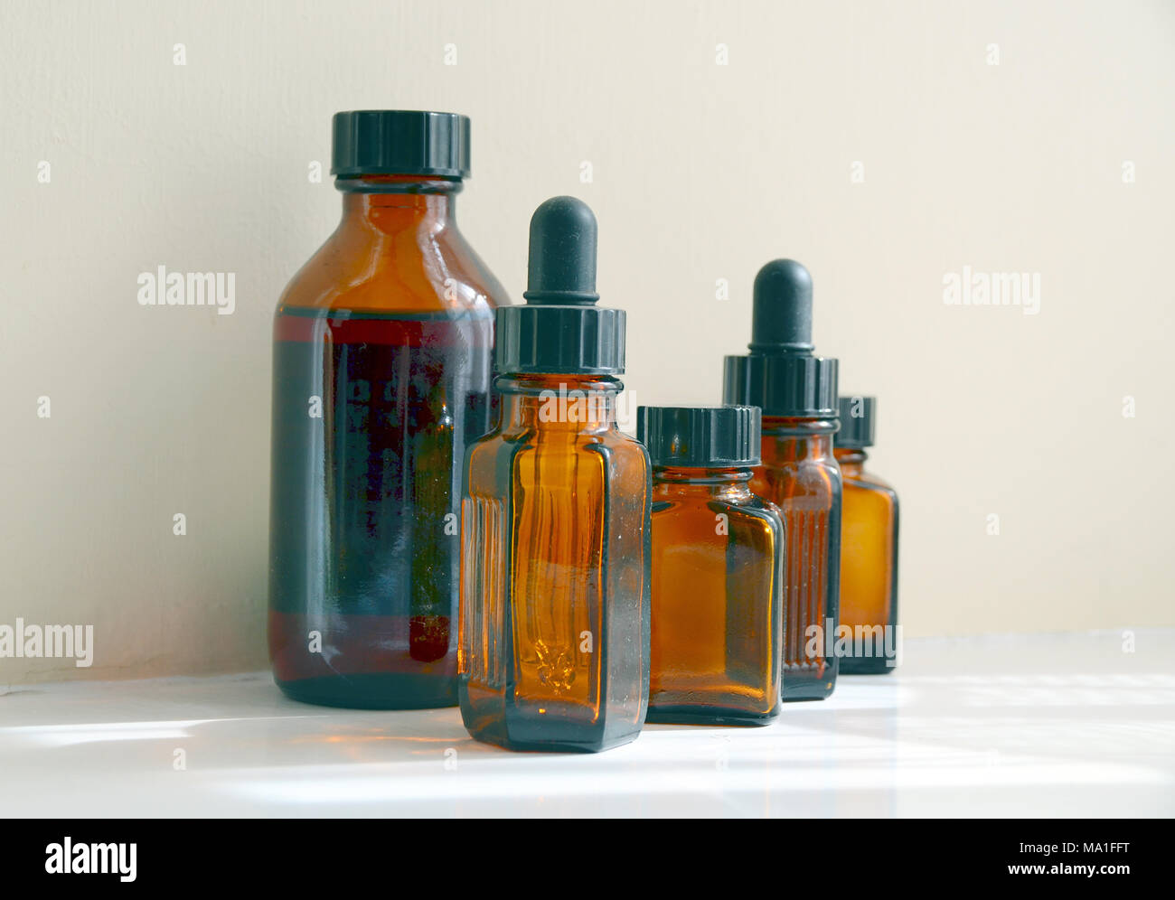 Eine Person weist Arzneimittel Öl bis eine Pipette aus der gelben Flasche. Stockfoto