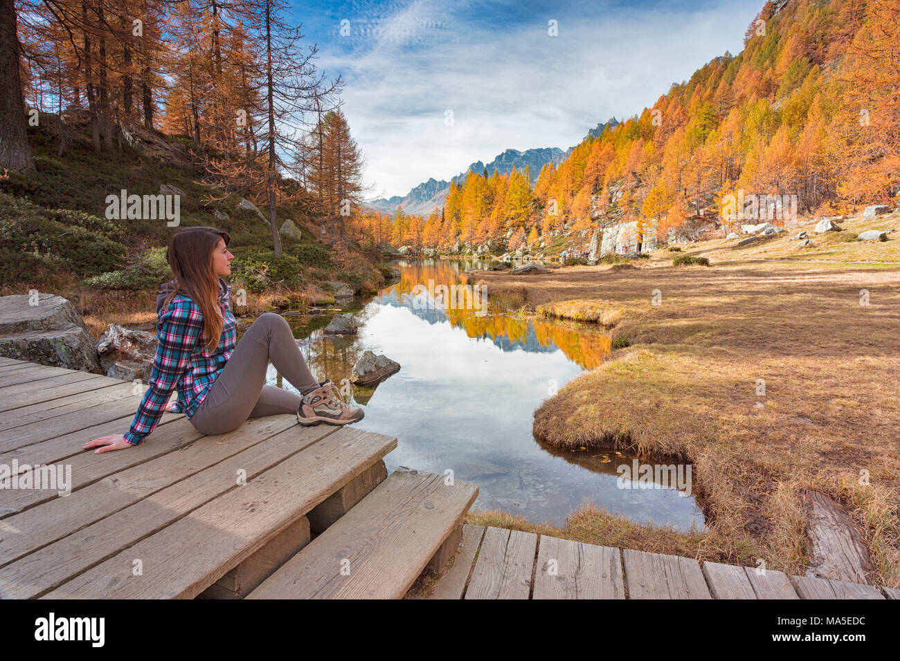 Eine Frau am kleinen See in der Nähe von als Hexen Crampiolo See, Alpe Veglia und Alpe Devero Naturpark, Baceno, Provinz Verbano Cusio Ossola, Piemont, Italien bekannt starren Stockfoto