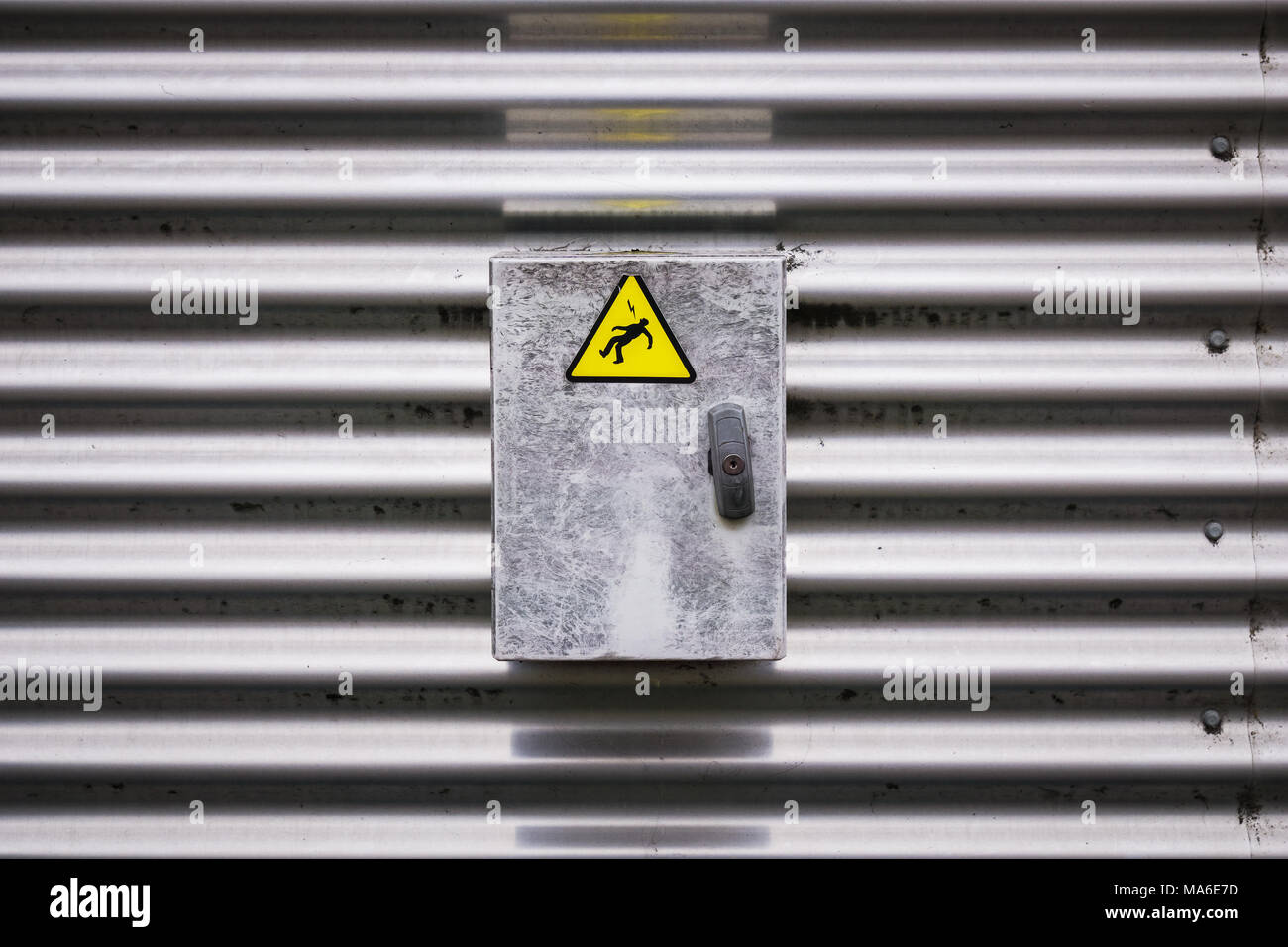 Detailansicht eines elektrischen Feld mit einem Warnschild Aufkleber entspricht einem elektrischen Stuhl person Silhouette. Stockfoto