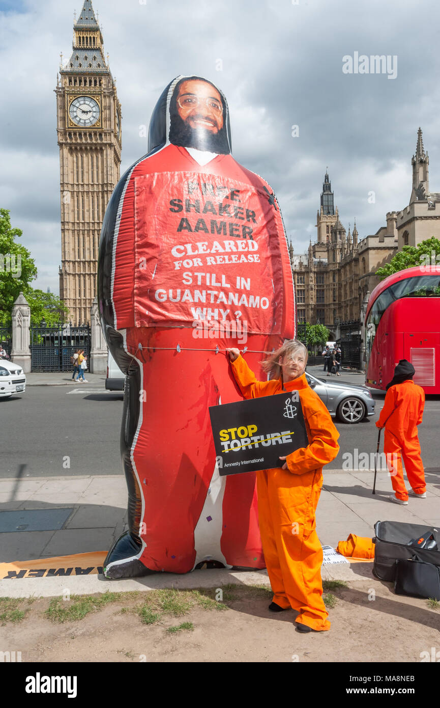 Tania Mathias, gewählt Letzten Monat als konservativ MP für Twickenham Posen mit einer Amnestie Poster top Folter" und einem riesigen aufblasbaren Shaker Aamer vor Big Ben. Stockfoto