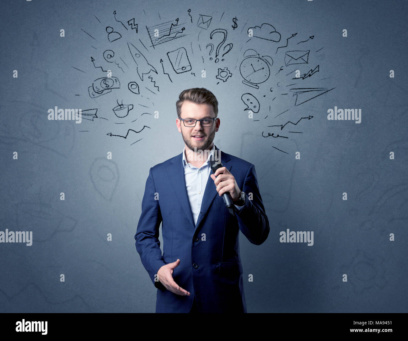 Geschäftsmann sprechen in das Mikrofon mit gemischten Doodles über seinem Kopf Stockfoto
