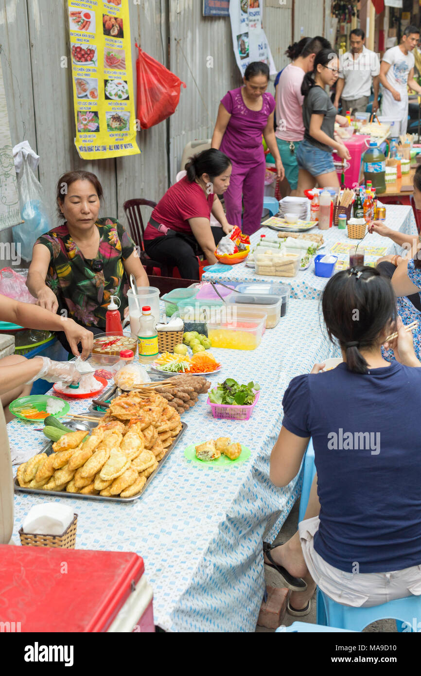 Lokale vietnamesische Leute essen zu einem Street Restaurant in Hanoi Old Quarter, Vietnam Stockfoto