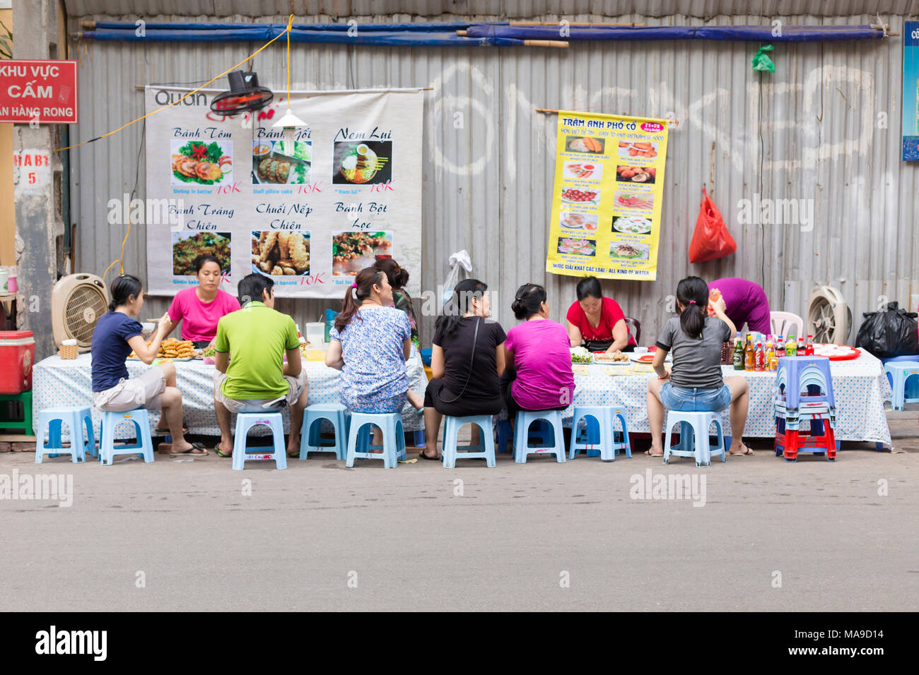 Lokale vietnamesische Leute essen zu einem Street Restaurant in Hanoi Old Quarter, Vietnam Stockfoto