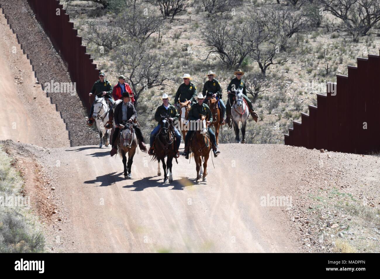 Us-Staatssekretär des Innern Ryan Zinke, Zentrum, Ausritte zu Pferde mit US Border Patrol Offiziere entlang der US-mexikanischen Grenze im Buenos Aires National Wildlife Refuge, den 17. März 2018 in der Nähe von Sasabe, Arizona. Zinke besucht die Grenze Grenzsicherung und ressortübergreifende Zusammenarbeit mit US-amerikanischen Zoll- und Grenzschutz zu bewerten. Stockfoto