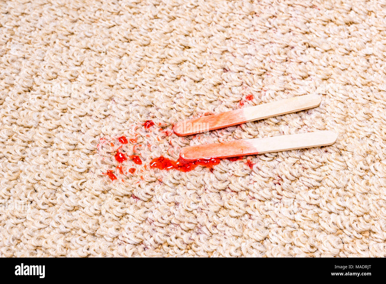 Einem Time Lapse-Videorecorder eines schmelzenden Popsicle auf weißen Teppich zeigt die eisigen behandeln in einem klebrigen Saft schmelzen und rechts in den Teppich zu absorbieren. Stockfoto