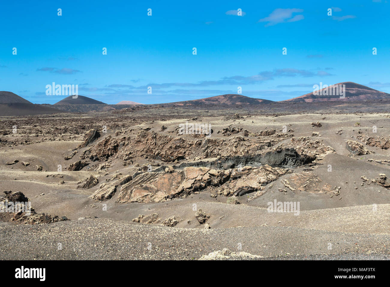 Lava und Krater Landschaft des Timanfaya in Lanzarote, Spanien mit blauem Himmel. Stockfoto