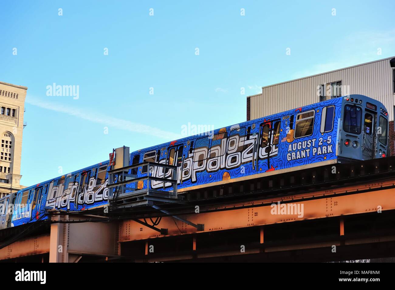 Chicago, Illinois, USA. Ein CTA-Schnellzug, der hell geschmückt ist mit Werbung, die den berühmten Loop von Chicago verlässt. Stockfoto