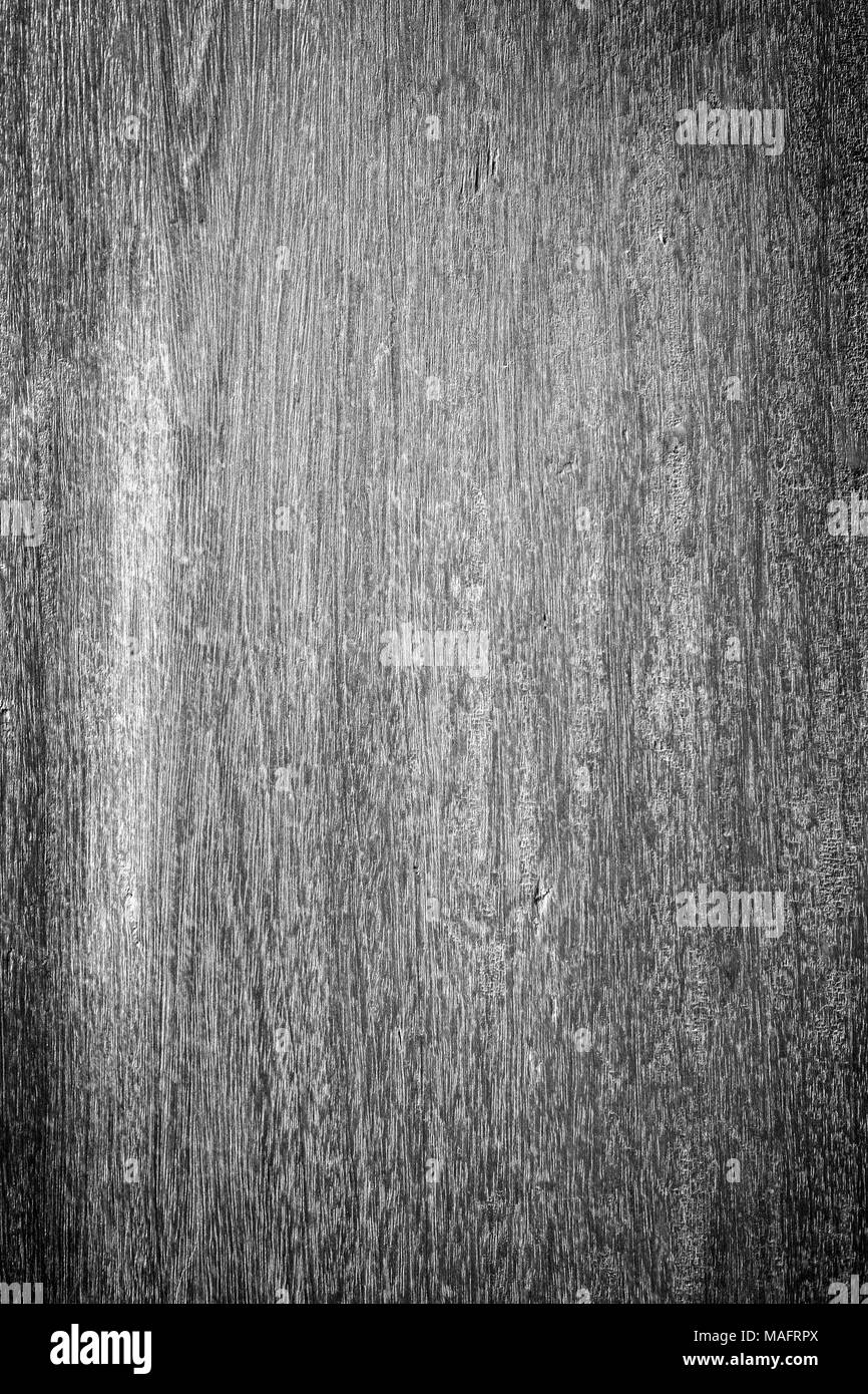 Nahaufnahme einer verblassten Holzplatte wand Textur Hintergrund mit Vignette in Schwarz und Weiß. Stockfoto
