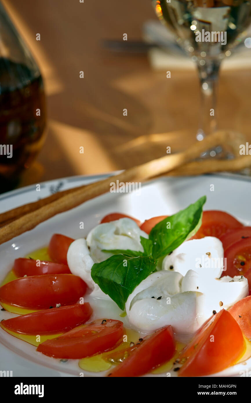 Bild von Tomaten und Mozzarella Salat mit Olivenöl Stockfoto