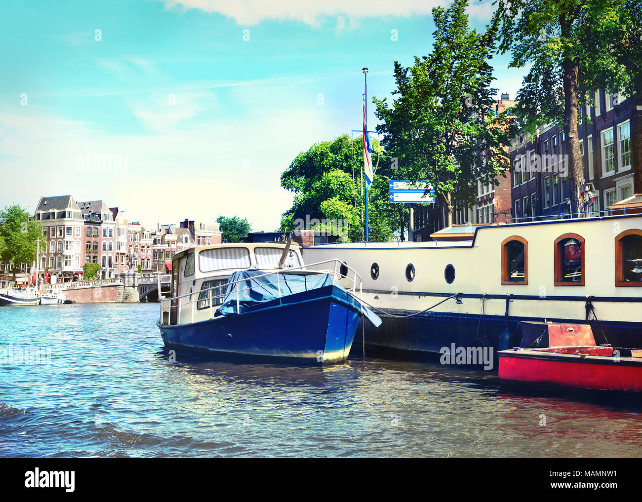Kanal von Amsterdam mit dem niederländischen Häusern und Amstel. Im Frühling oder im Sommer zur Szene und das Stadtbild von Amsterdam. Historische Stadthäuser. Stockfoto