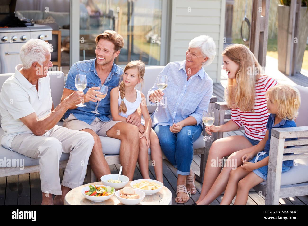Multi-Generation Familie Outdoor Getränke und Snacks zu Hause Stockfoto