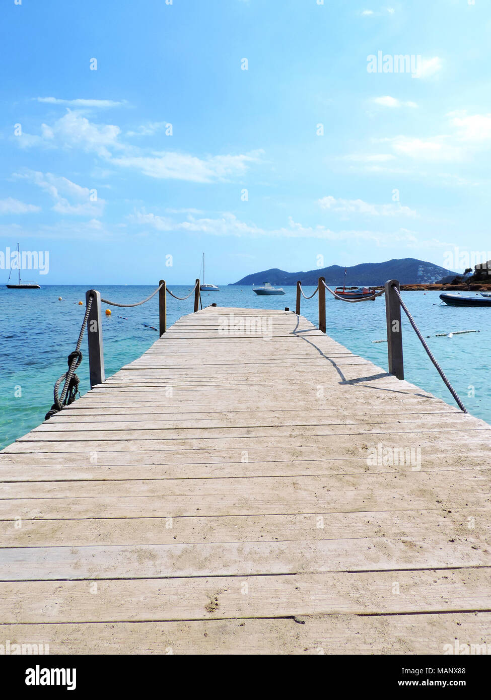 Holzbrücke oder Pier im Meer. Türkisfarbenes Wasser und idyllische Jetty. Stockfoto