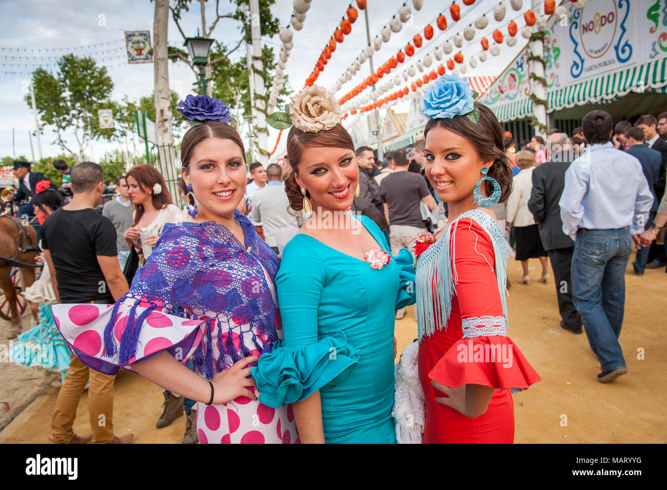 Junge Frauen in bunten Flamenco-Kleider auf der Sevilla April Messe, Spanien Stockfoto