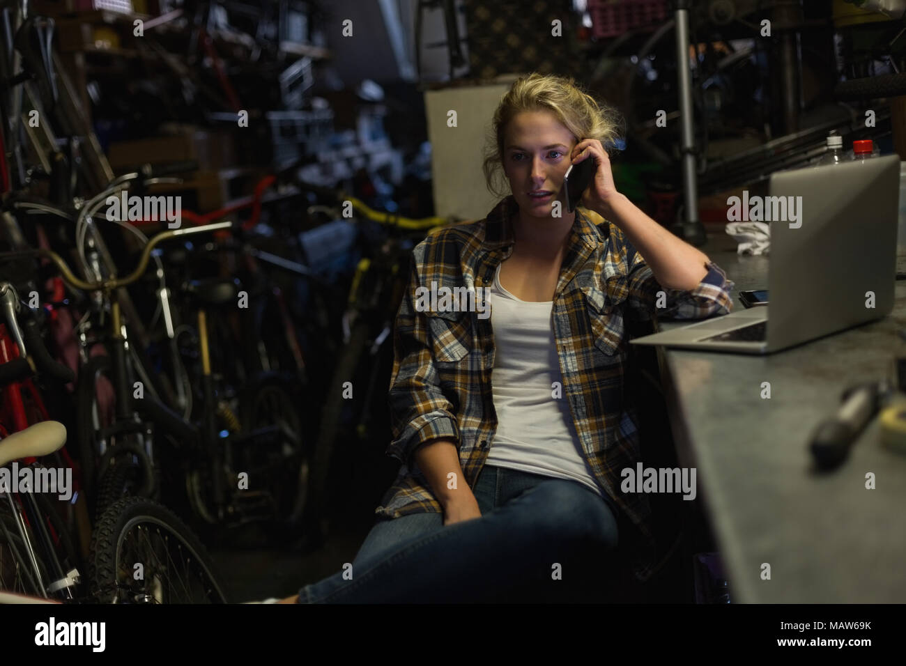 Weibliche Mechaniker telefonieren mit Handy Stockfoto