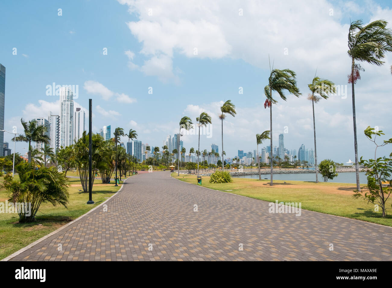 Bürgersteig an öffentlichen Park mit Skyline der Stadt an der Uferpromenade in Panama City Stockfoto