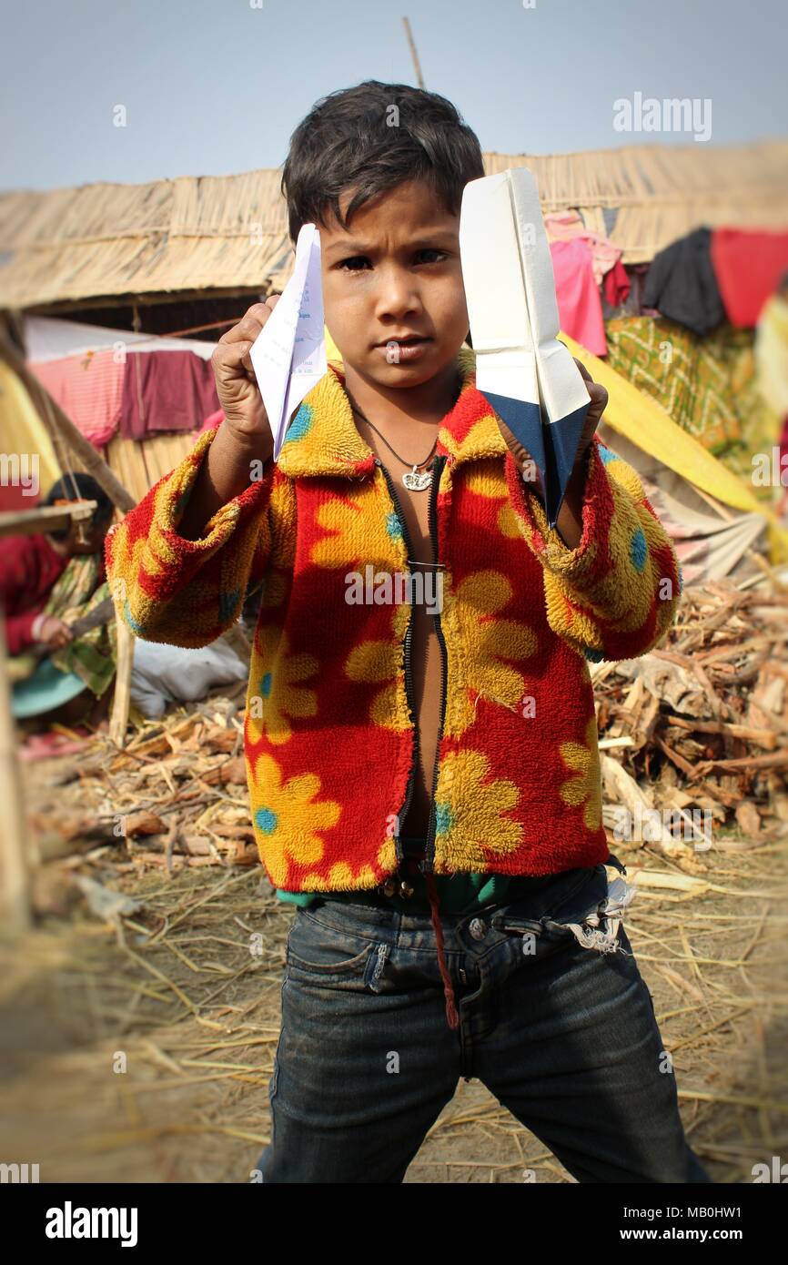 Porträt einer indischen armen Dorf Junge spielt mit handgefertigten Paper Plane Stockfoto