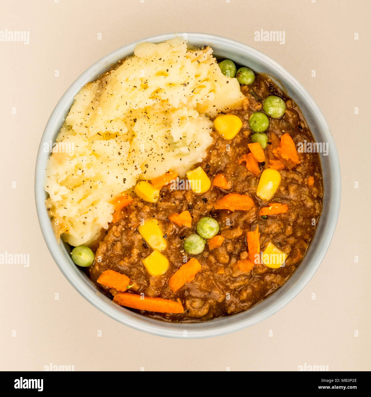 Pflegende Cottage Pie Mahlzeit in einer Schüssel gegen einen hellgrauen Hintergrund Stockfoto