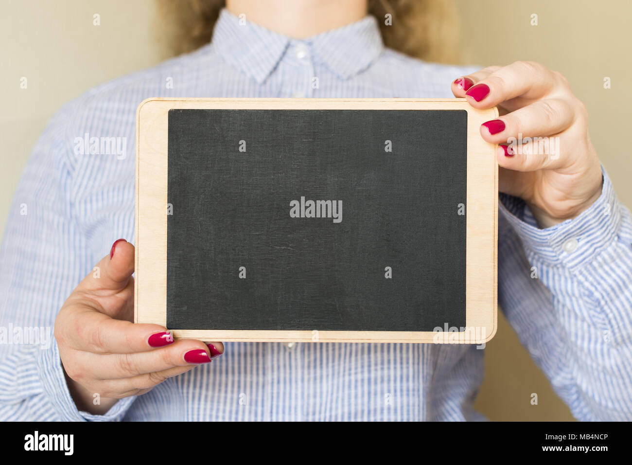 Junge Frau mit einem kreidetafel mit Platz für Text in Ihre Hände, Nahaufnahme Stockfoto